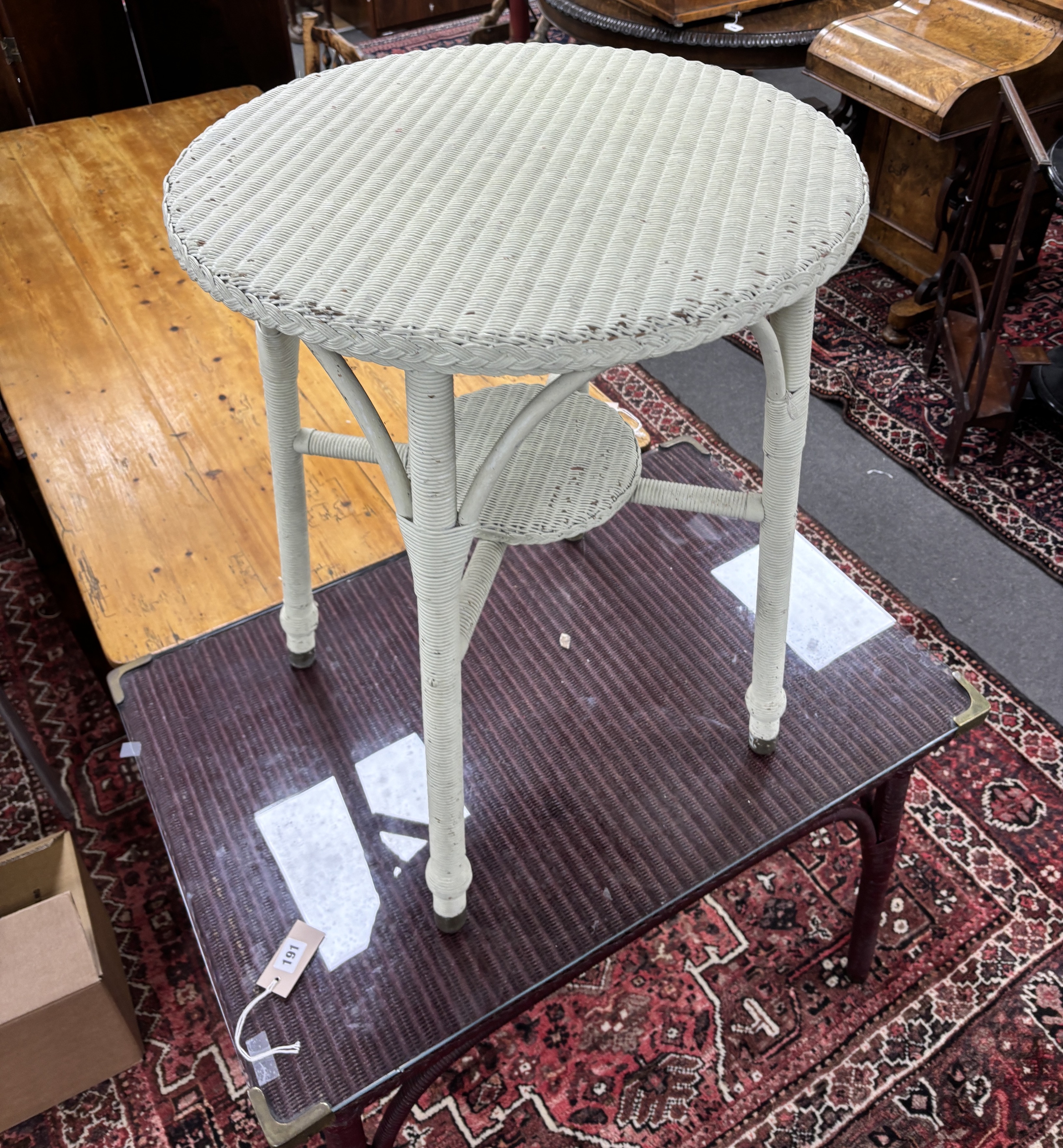 A Lloyd Loom rectangular table, width 91cm, depth 61cm, height 73cm together with a smaller circular Lloyd Loom table